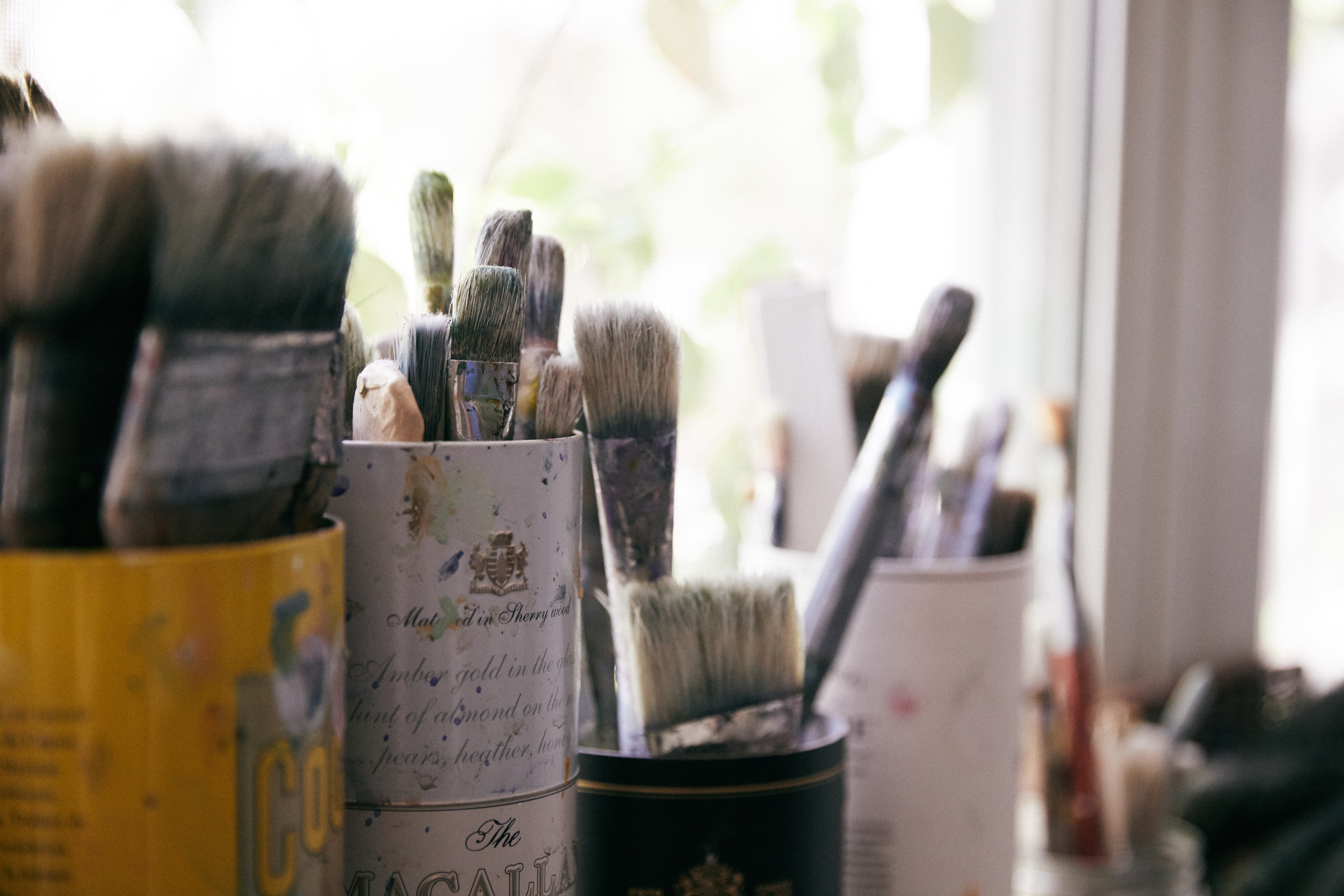 A closeup photo of paint brushes in an art studio