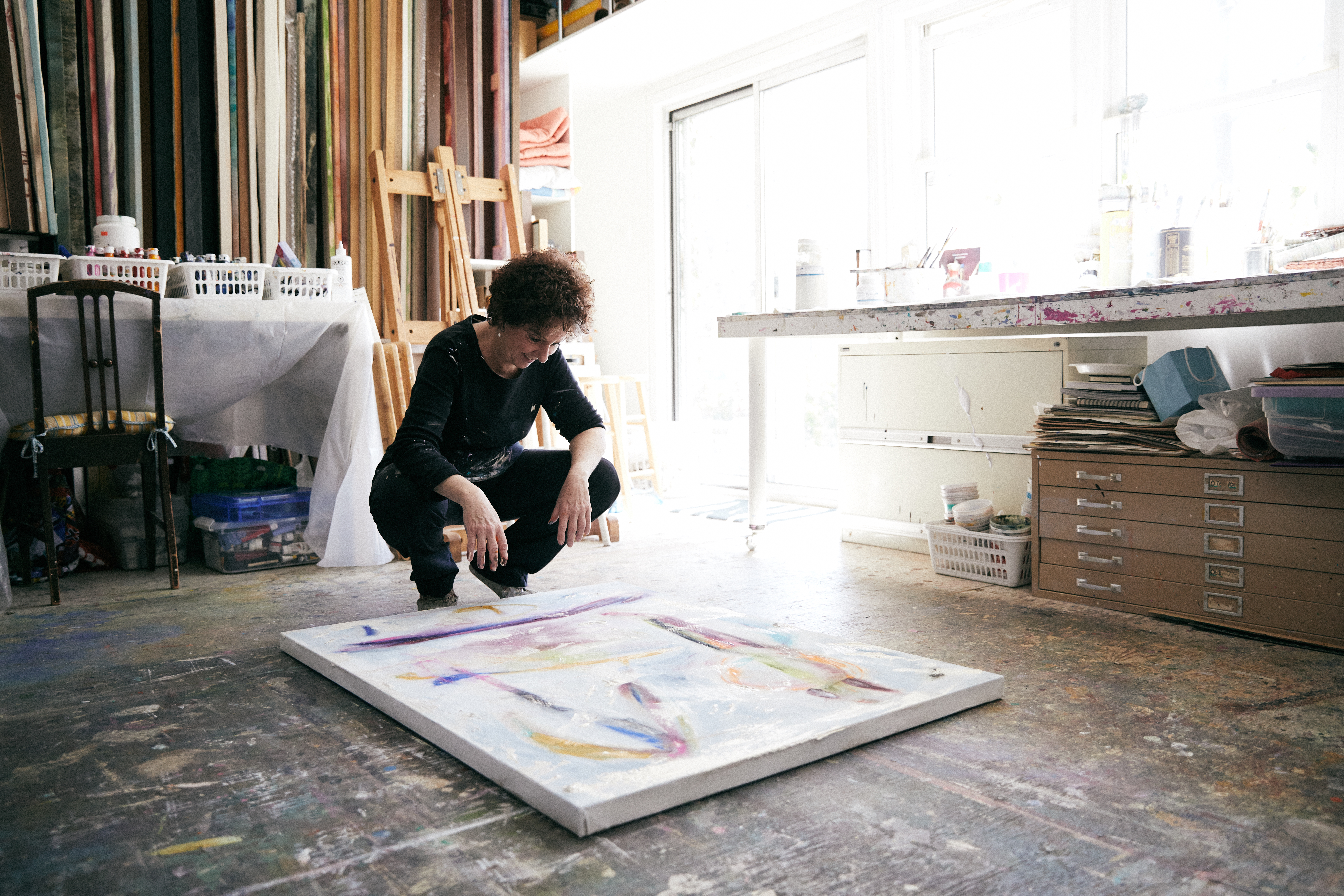 Judy Singer, artist in Canada, infront of one of her paintings