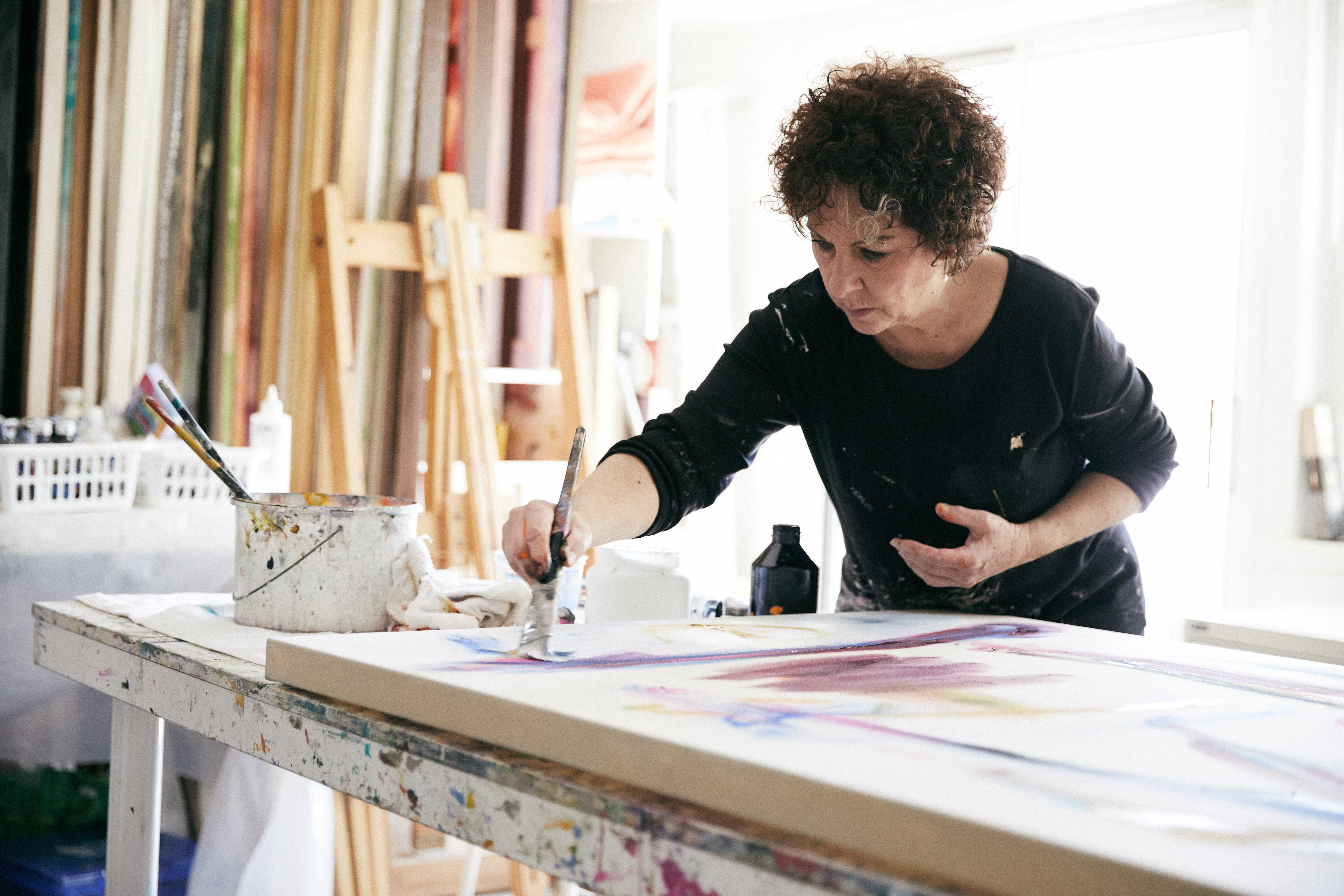 Judy Singer, a creative entrepreneur, painting in her studio